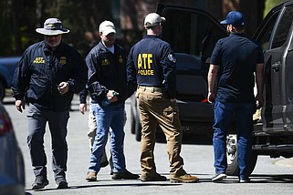 ATF agents wait outside as the Arkansas State Police Criminal Investigation Division investigates an officer-involved shooting that occurred March 19 in Little Rock. The ATF was serving a federal search warrant on the home of former  Clinton National Airport executive director Bryan Malinowski, 53, who was fatally shot during the raid. (Arkansas Democrat-Gazette/Stephen Swofford)